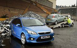 New Ford Focus with Mk1 Ford Focus heading for the scrapyard