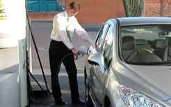 Businessman filling up a Peugeot with fuel