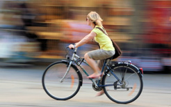 A woman cycles to work on a bike leased from her company under the Cycle to Work scheme