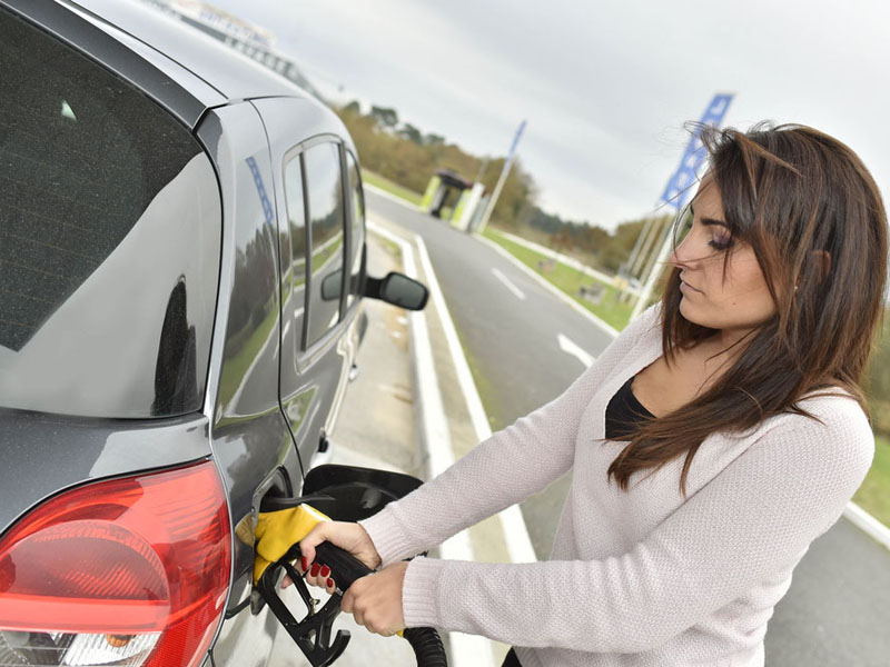 Woman filling up with fuel