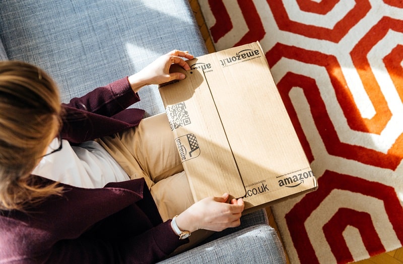 Woman opening Amazon package photo Hadrian Shutterstock