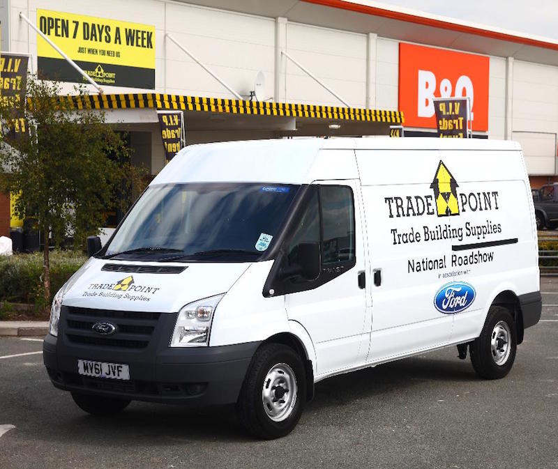 White Ford Trade Point van parked outside B&Q store with yellow and black striped awning.