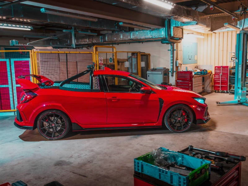 Red Honda Civic Type R pickup truck concept in workshop with turquoise overhead crane and storage bins.