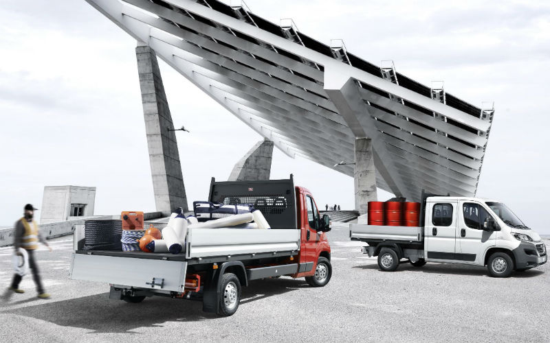Fiat Professional vehicles with modular conversion kits displayed on a rooftop, including tipper, cargo and utility…