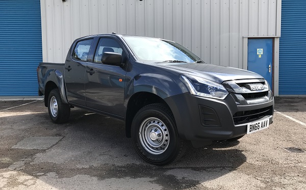 Isuzu D-Max 1.9 Utility 4×4 double cab pickup truck in black, parked in front of industrial building.
