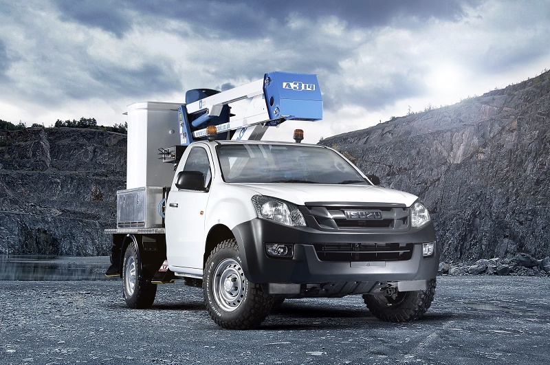 White Isuzu D-Max pickup truck with forestry equipment mounted on roof, parked in quarry setting with rocky cliff face…