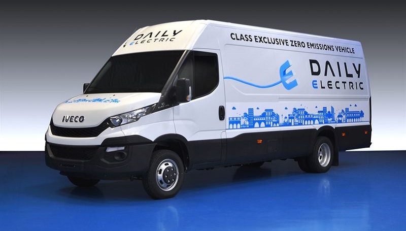 Iveco New Daily Electric van in white livery with blue city skyline graphic, badged as zero emissions vehicle winner.