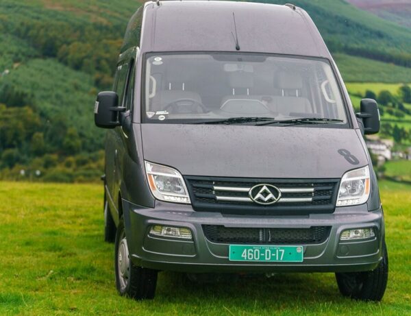Grey LDV V80 High Roof LWB van parked on grass with rolling hills in background.