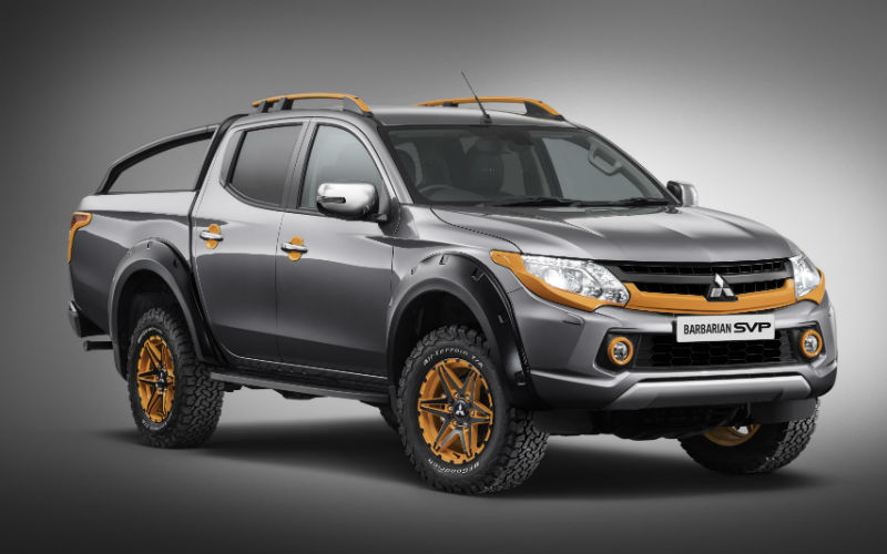 Mitsubishi L200 Barbarian SVP II pickup truck with grey body, gold accents, roof bars and enhanced styling against neutral…