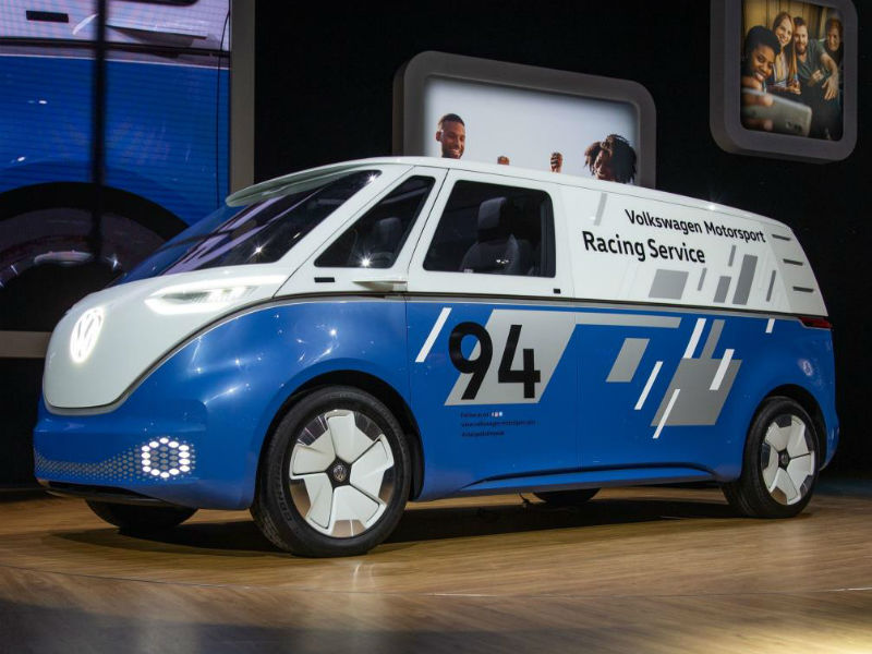 Blue and white Volkswagen Motorsport Racing Service concept vehicle displayed in showroom with number 94 livery.