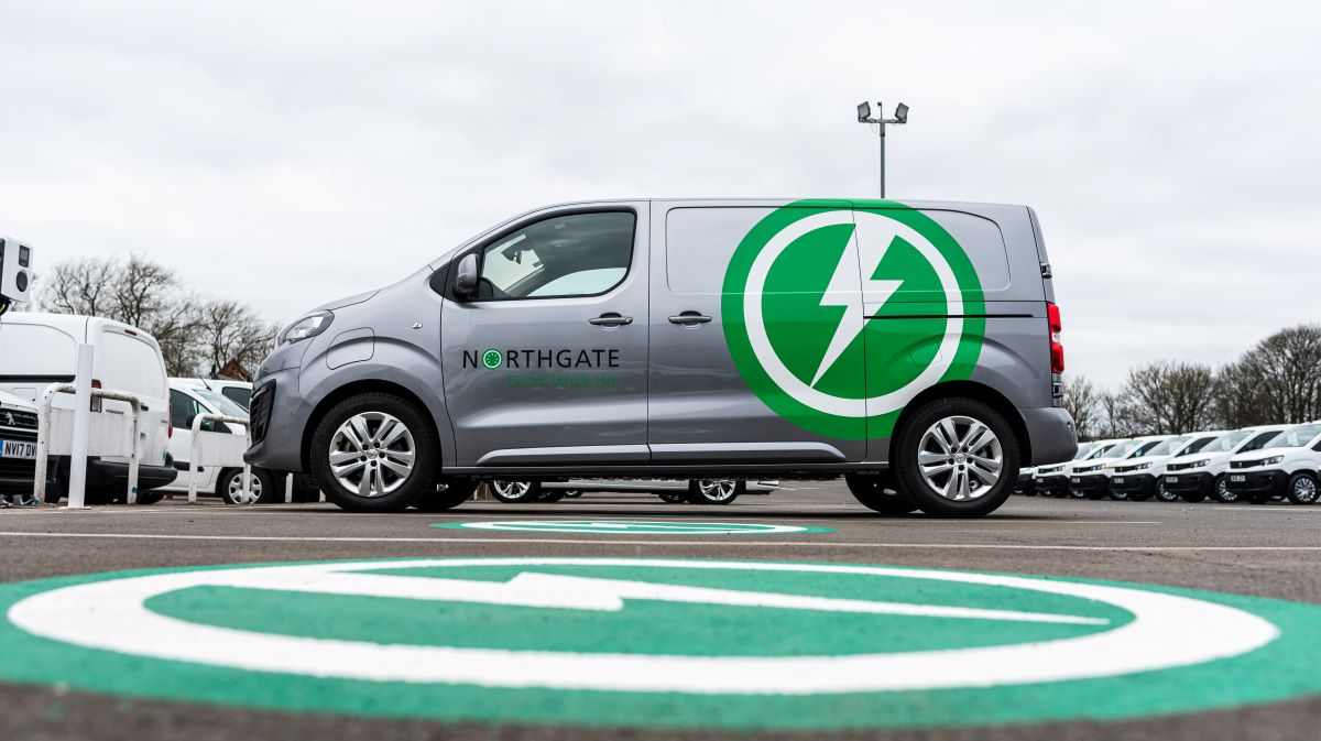 Northgate electric van parked on green charging pad marked with lightning bolt symbol.