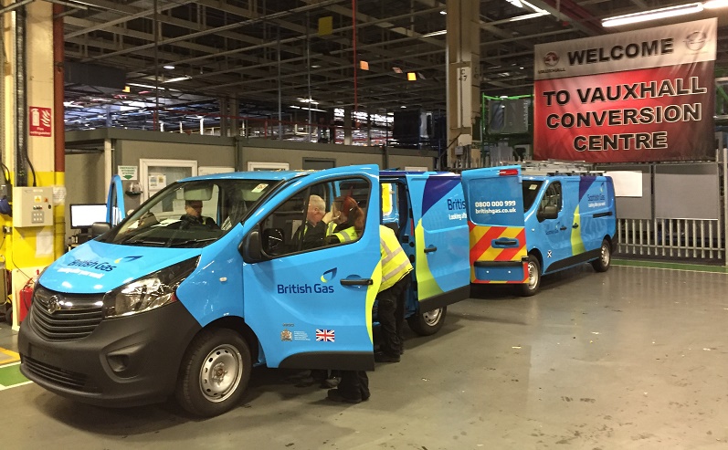 Three british gas branded Vauxhall vans at the Vauxhall Conversion Centre, with technician standing by the open door of…
