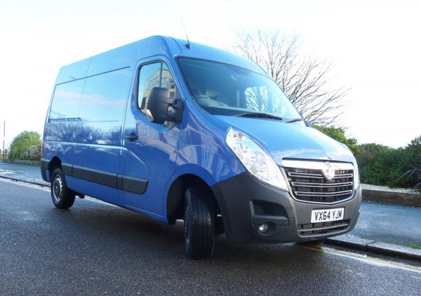 Blue Vauxhall Movano van parked on tarmac with bare trees in background.
