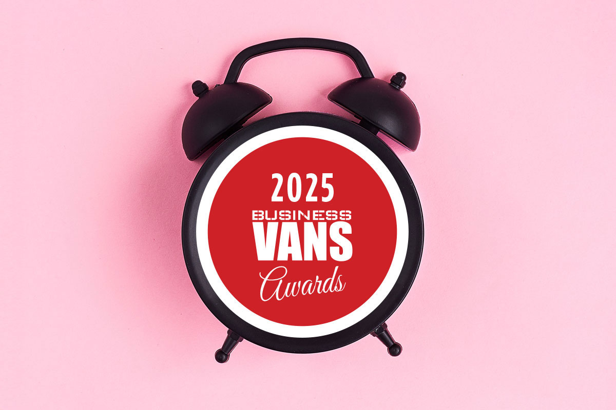 Black alarm clock with red centre displaying 2025 Business Vans Awards logo on pink background