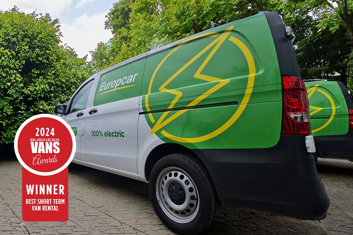 Green Europcar electric van with yellow lightning bolt logo, displaying 2024 Vans Awards winner badge for best short-term…