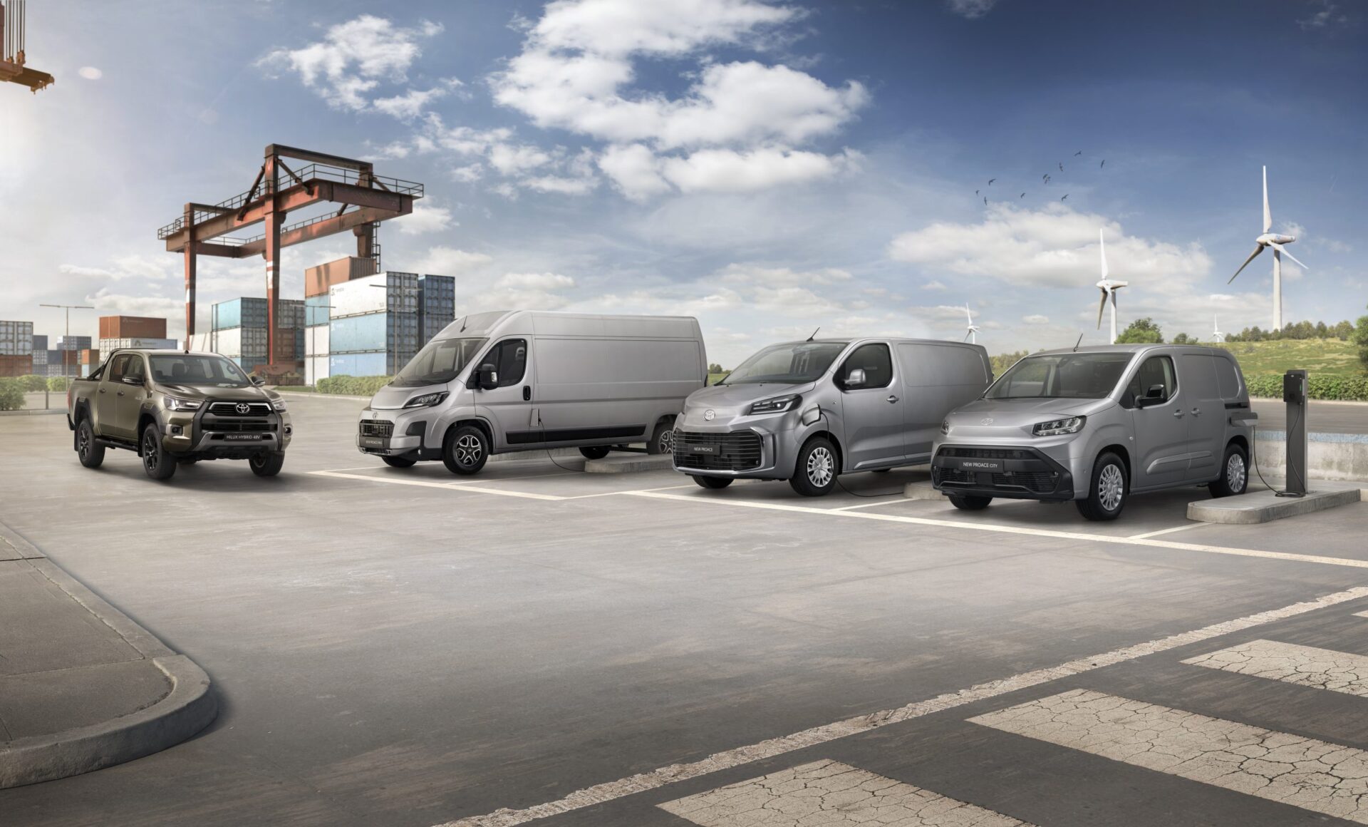 Toyota Professional vehicle range lined up at industrial port setting with shipping containers and wind turbine visible.