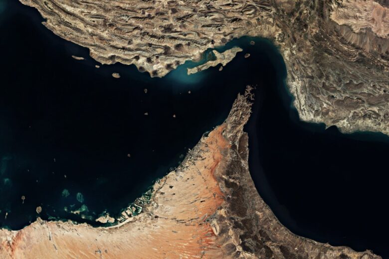 Satellite view of the Persian Gulf with surrounding desert coastlines and shipping routes visible in turquoise waters.