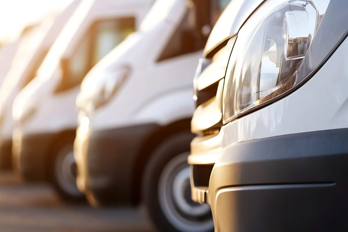 Line of parked delivery vans showcasing modern transportation solutions during golden hour in a serene environment : Generative AI