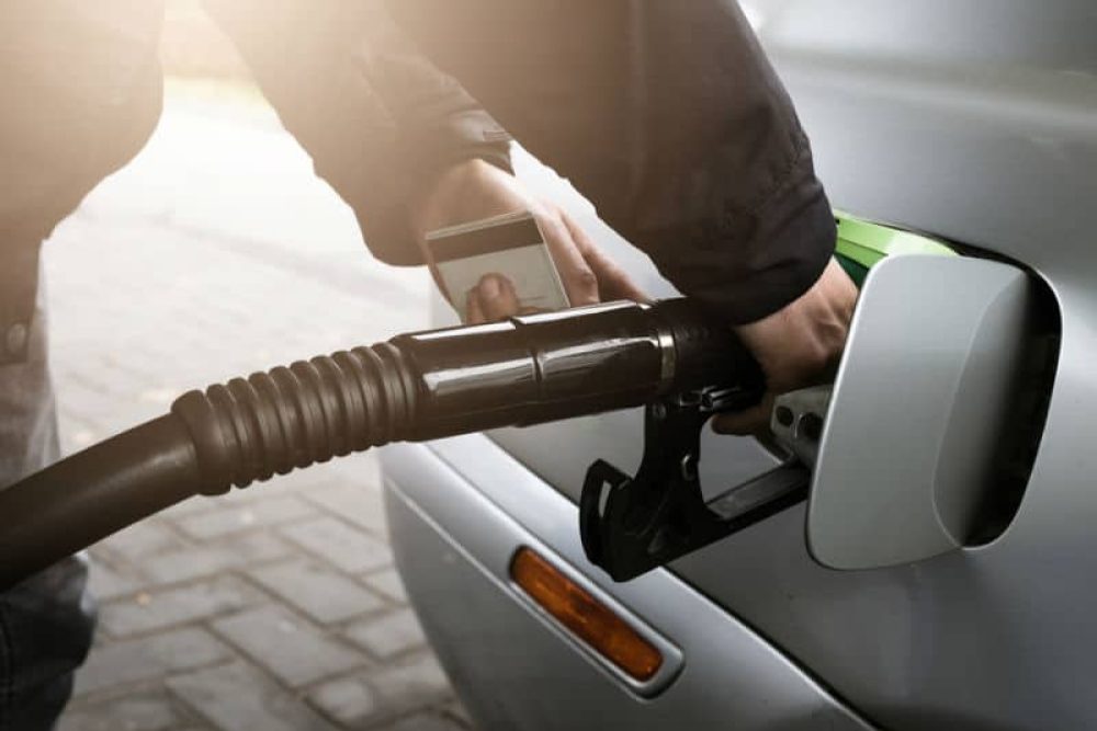 Man filling up company car with fuel