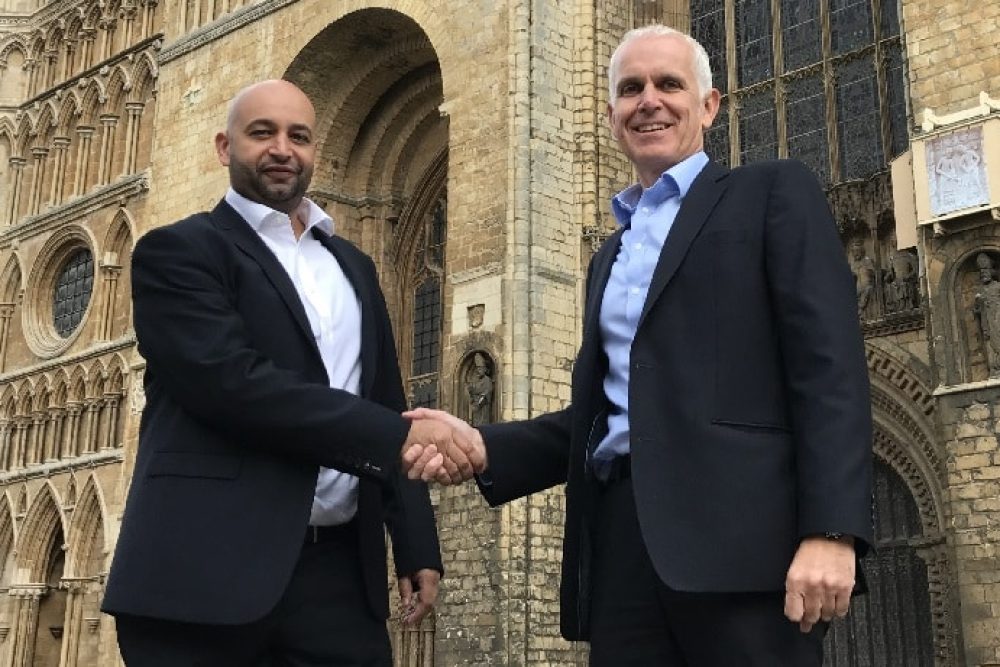 Ogilvie _James Parczuk L MD Active Auto Solutions and Duncan Ogilvie CExex Ogilvie Group shake hands on the acquisition in front of Lincoln Cathedral