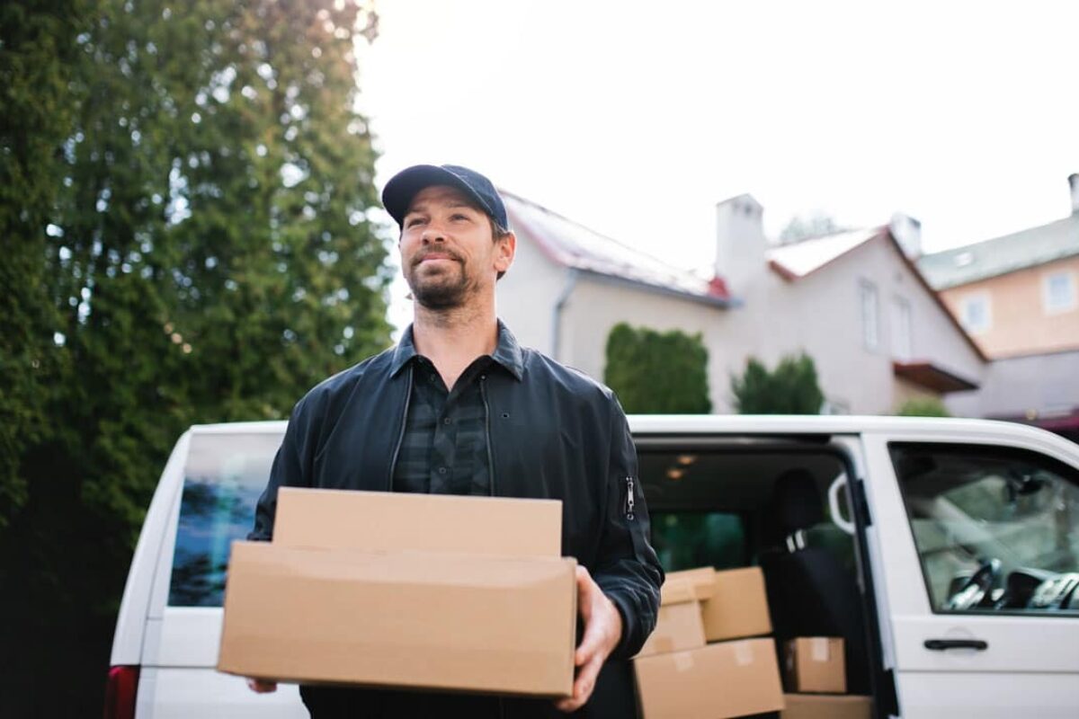 portrait-of-delivery-man-courier-delivering-parcel-2023-11-27-05-15-09-utc