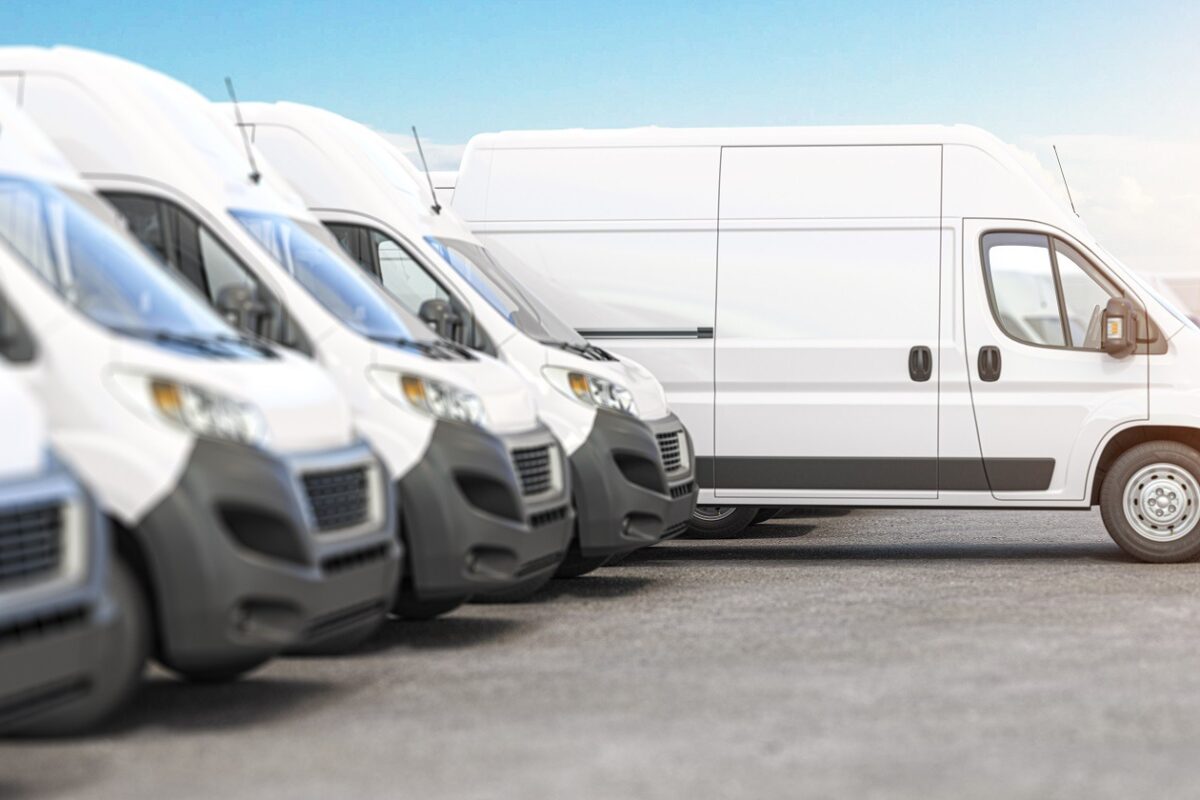 Delivery vans in a row with space for logo or text. Express delivery and shipment service concept.